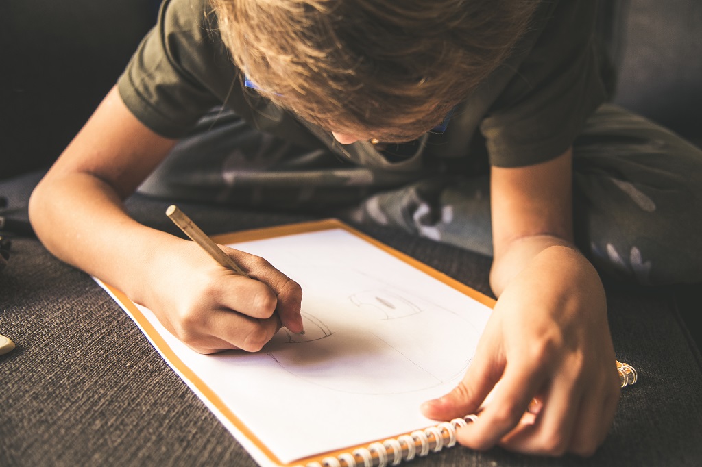 Little boy drawing on paper