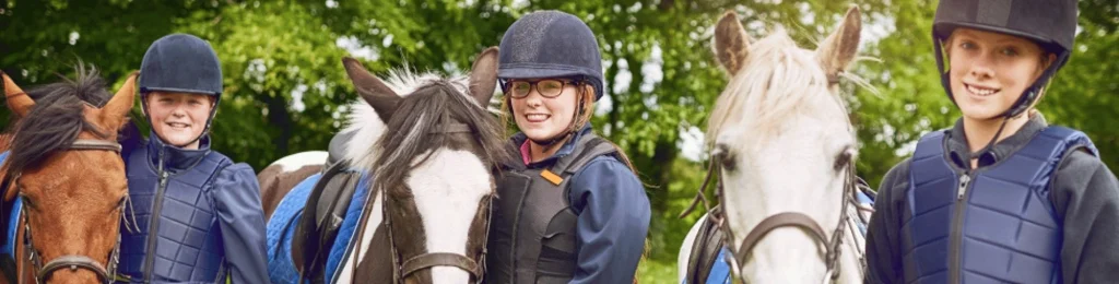 three children with different horses