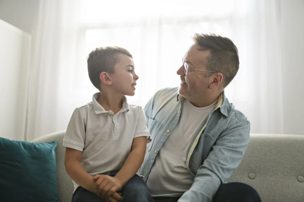 foster parent talking and laughing with a young boy